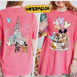May include: Pink t-shirt featuring a colorful graphic of Chip and Dale in a teacup with balloons, and a castle scene on the back. The word "WATERMELON" is in a yellow banner at the top.