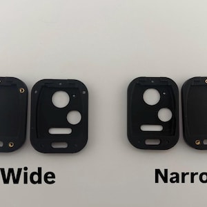 May include: Black rectangular watch case components, labeled "Wide" and "Narrow". Each component has a series of holes and gold-colored metal inserts. The "Wide" components are on the left, and the "Narrow" components are on the right.