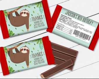 May include: Printable template for a chocolate bar wrapper featuring a cartoon sloth hanging from a branch. The wrapper is red and blue with green leaves. The text on the wrapper says "Thanks Hanging Out With You Was Slow Much Fun".