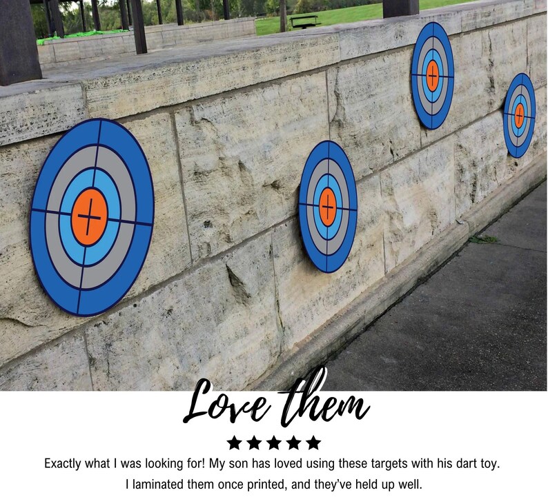 May include: Four blue and grey dart targets with orange and white centres are mounted on a stone wall. The targets are arranged in a row, with the largest target on the left and the smallest target on the right. The targets are made of a durable material and are perfect for use with darts.