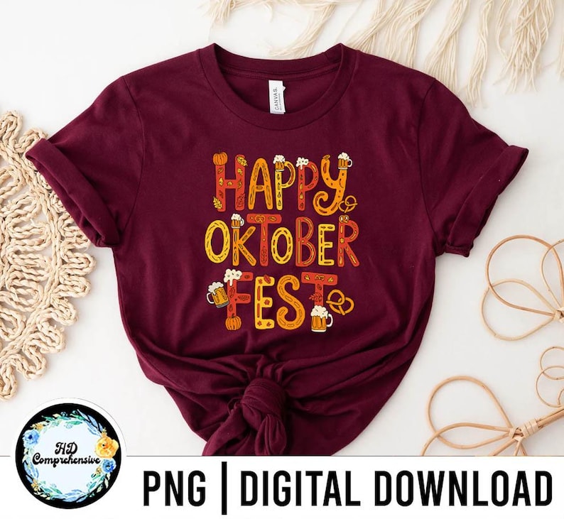 May include: A maroon t-shirt with the words "HAPPY OKTOBER FEST" in orange and yellow lettering. The design includes beer steins, pretzels, and pumpkins. The bottom of the shirt has the text "PNG | DIGITAL DOWNLOAD".
