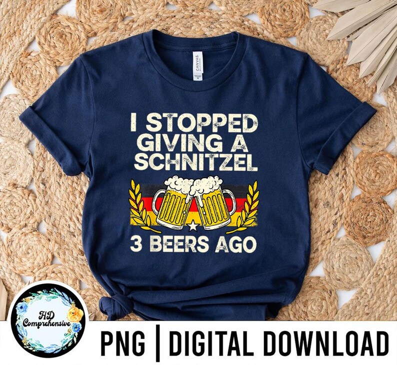 May include: Navy blue t-shirt with the text "I STOPPED GIVING A SCHNITZEL 3 BEERS AGO". The design includes two beer mugs with foam and the German flag colors. The shirt is a digital download.