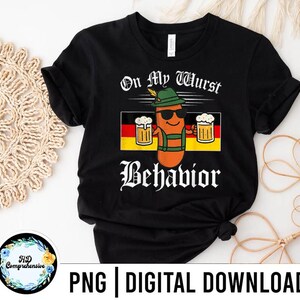 May include: Black t-shirt with the text "On My Wurst Behavior" and a cartoon sausage character wearing sunglasses, a hat, and lederhosen, holding two mugs of beer. The German flag is in the background.