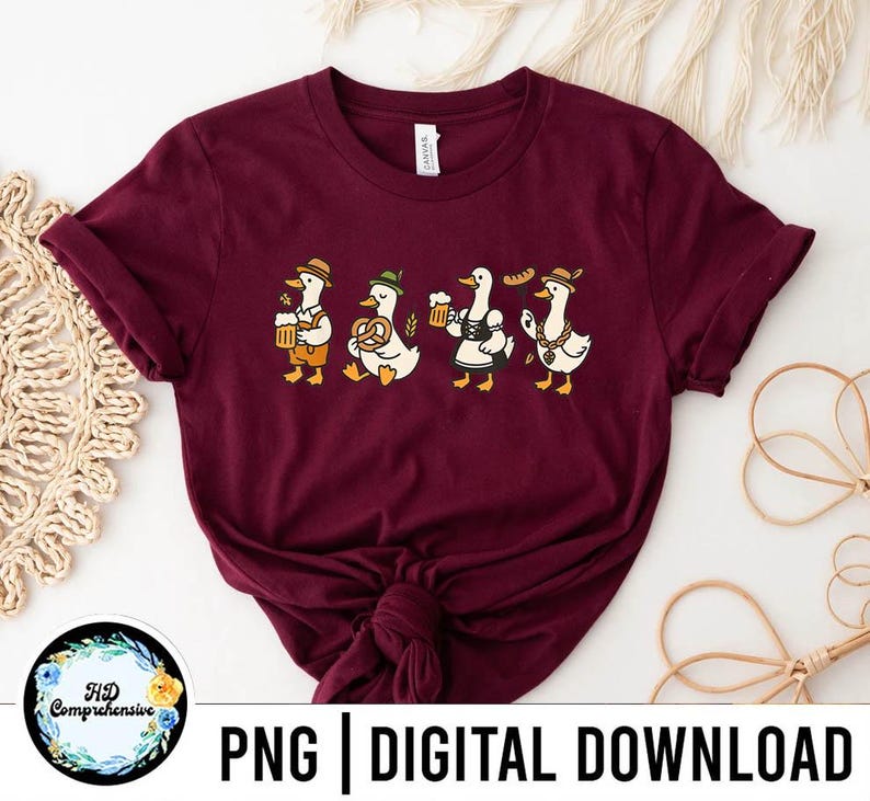 May include: Burgundy t-shirt featuring a whimsical illustration of four ducks in traditional Bavarian attire. Each duck is depicted with a different accessory, including beer steins, pretzels, and sausages. The text "PNG | DIGITAL DOWNLOAD" is at the bottom.