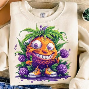 May include: A cream-coloured sweatshirt with a cartoon pineapple character, smiling widely and wearing orange trainers. The design includes green leaves and purple berries. A fun and colourful design, suitable for everyday wear.