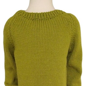 May include: A green knitted sweater with a round neckline and long sleeves.
