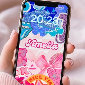 May include: A colorful phone wallpaper with a variety of stickers, including a cheetah, a butterfly, a pink bow, and the name "Amelia". The phone screen displays the time "20:28" and the date "Sunday, December 1".