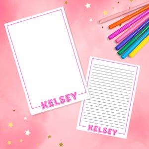 May include: Two printable stationery sheets with a pink border and the name "Kelsey" in pink bubble letters. The sheets are on a pink background with gold stars.