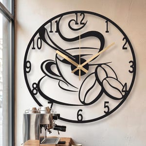 May include: A circular black wall clock featuring a cutout design of a coffee cup with steam and coffee beans. The clock face displays black numbers from 1 to 12 around the perimeter and includes two thin gold-colored hands for timekeeping.