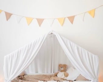 May include: A white canopy bed with a brown and white checkered blanket and a brown teddy bear. The bed has two drawers and a brown storage organizer. A garland of triangular flags hangs above the bed.