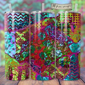 May include: Three stainless steel tumblers with lids and straws. The tumblers feature a colorful patchwork design with shades of teal, pink, red, and yellow. The text "10 free wraps" is visible on a banner above the tumblers.