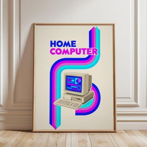 May include: A framed poster featuring a beige vintage home computer with a keyboard and monitor displaying pixelated graphics. The text HOME COMPUTER appears in blue and pink above the computer, surrounded by vertical blue, pink, and cyan stripes.