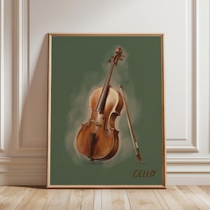 Op de afbeelding: Een ingelijste wandkunstprint met een bruine houten cello en een strijkstok gecentreerd tegen een effen olijfgroene achtergrond. Het woord CELLO is in een eenvoudig bruin lettertype in de rechterbenedenhoek van het rechthoekige kunstwerk gedrukt.