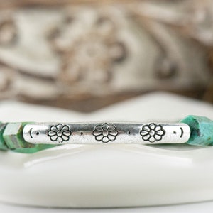 African Turquoise Stretch Bracelet close up of silver pewter tube focal bead adorned with floral etchings