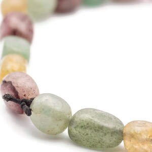May include: A close-up of a multi-coloured beaded necklace with a black cord. The beads are a mix of green, pink, and yellow.