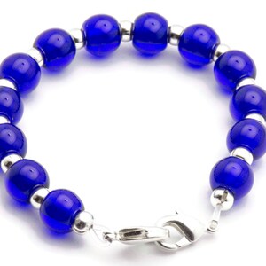 May include: A blue glass bead bracelet with silver spacers and a silver clasp.