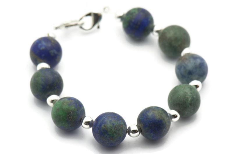 May include: A blue and green gemstone bracelet with silver beads and a silver clasp.
