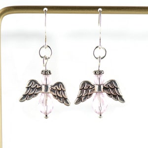 May include: Silver angel wing earrings with pink crystal beads.