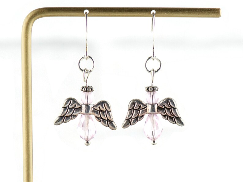 May include: Silver angel wing earrings with pink crystal beads.