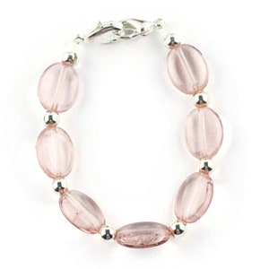 May include: A pink glass bead bracelet with silver beads and a silver clasp.