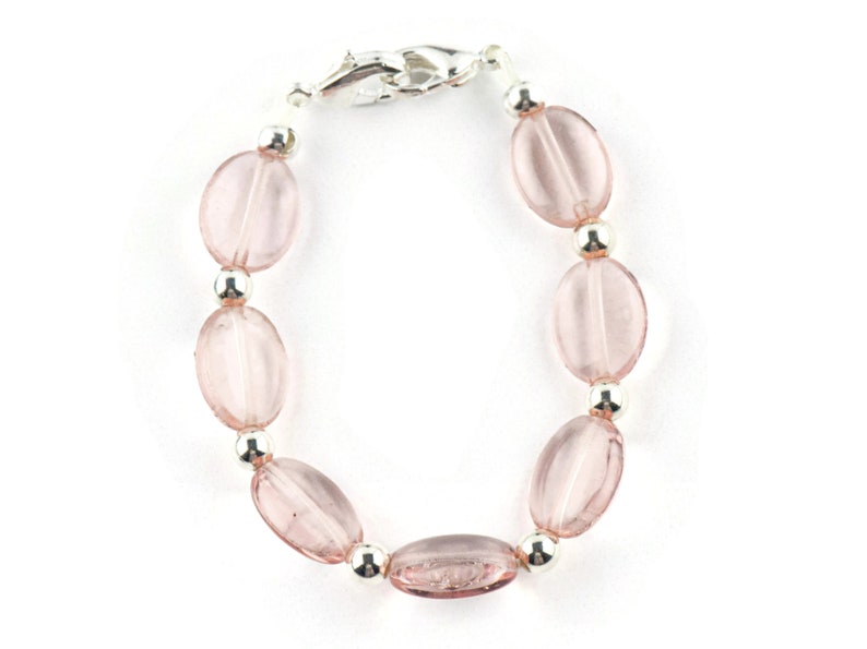 May include: A pink glass bead bracelet with silver beads and a silver clasp.
