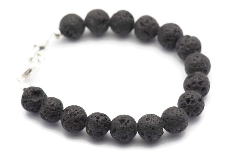 May include: A black lava rock beaded bracelet with a silver clasp.
