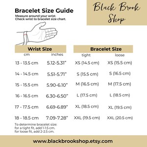 May include: A chart showing bracelet size guide in inches and centimetres. The chart shows wrist size in centimetres and inches, and corresponding bracelet size in centimetres for a tight and loose fit. The chart also includes instructions on how to determine bracelet size for a tight or loose fit.