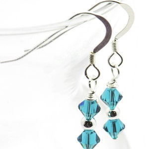 December Blue Zircon Swarovski Crystal Birth Month Sterling Silver Drop Earrings hanging on vase