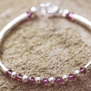 February Amethyst Swarovski Crystal Birth Month Sterling Silver Plated Bracelet on stone