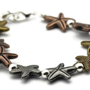 May include: A silver and bronze bracelet with a series of starfish charms. The bracelet is made of metal and has a clasp closure.