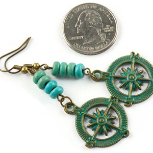 May include: Teal and bronze compass earrings with turquoise beads. The earrings are approximately the size of a UK 20 pence coin.
