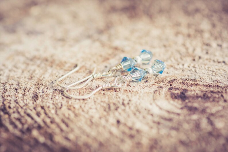 March Aquamarine Swarovski Crystal Birth Month Sterling Silver Drop Earrings on wood background