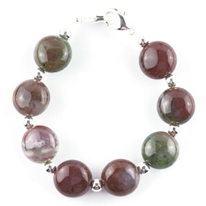 May include: A bracelet made with round, multi-colored agate beads and silver accents.