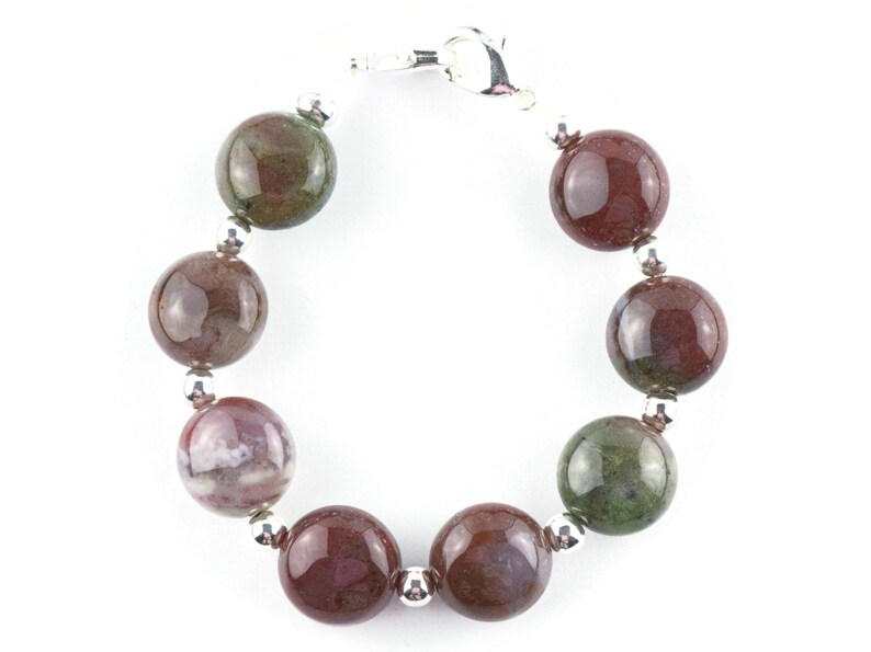 May include: A bracelet made with round, multi-colored agate beads and silver accents.