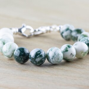 May include: A green and white agate beaded bracelet with a silver clasp.