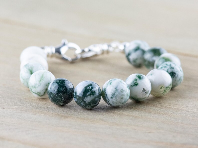 May include: A green and white agate beaded bracelet with a silver clasp.
