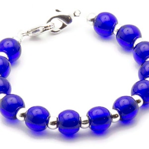 May include: A bracelet with alternating blue glass beads and silver beads. The bracelet has a silver clasp.