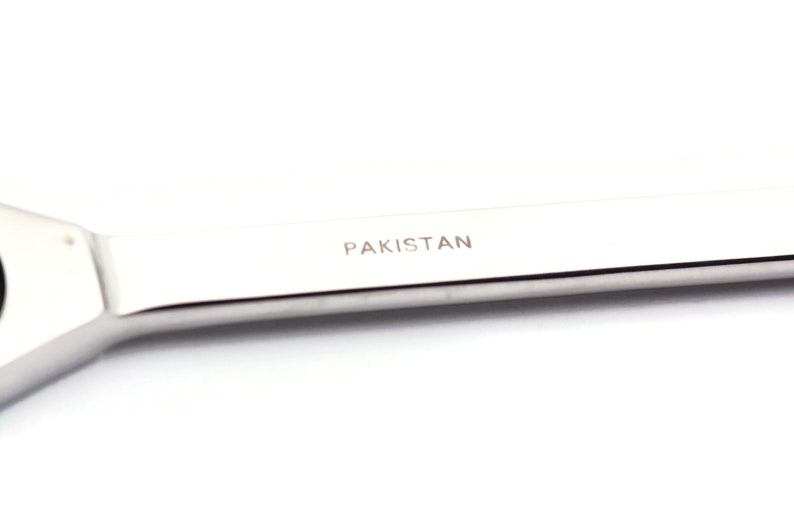 May include: A silver wrench with the word "PAKISTAN" engraved on the handle.