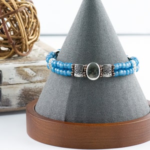Button and Bows French Blue Cuff Memory Wire Bracelet on a decorative black bracelet stand.