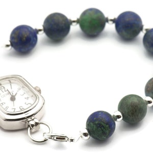 May include: A silver watch with a square face and a beaded bracelet. The beads are a mix of blue and green.