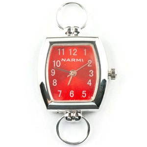 May include: A silver watch with a red face and white numbers. The watch has a square face with rounded corners and a silver band. The watch is attached to a silver chain with a ring at the top.