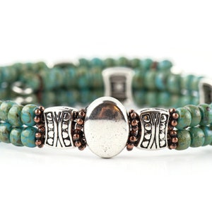 Button and Bows Desert Turquoise Cuff Memory Wire Bracelet on white background.