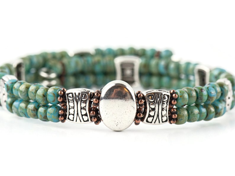 Button and Bows Desert Turquoise Cuff Memory Wire Bracelet on white background.