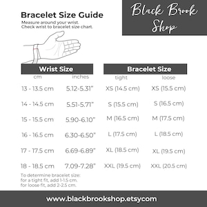 May include: A chart showing bracelet sizes in inches and centimetres. The chart includes a hand wearing a bracelet to illustrate wrist size. The chart also includes a table with bracelet sizes in inches and centimetres for both a tight and loose fit.