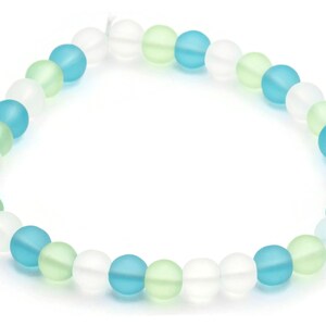 May include: A bracelet made of frosted glass beads in white, light blue, and light green.