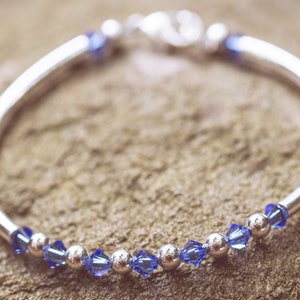 September Sapphire Swarovski Crystal Birth Month Sterling Silver Plated Bracelet on stone