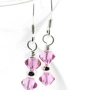 October Rose Swarovski Crystal Birth Month Sterling Silver Drop Earrings hanging on vase