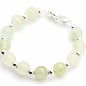 May include: A bracelet with light green jade beads and silver spacers.