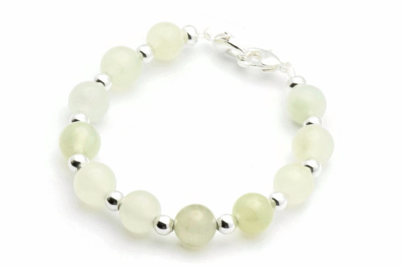 May include: A bracelet with light green jade beads and silver spacers.