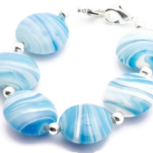 May include: A bracelet made of blue and white swirl glass beads with silver accents.
